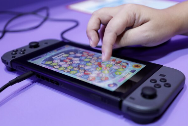 An attendant uses a Nintendo Co. Switch game console at the Tokyo Game Show 2019 in Chiba, Japan, on Sept. 12, 2019. MUST CREDIT: Bloomberg photo by Kiyoshi Ota.