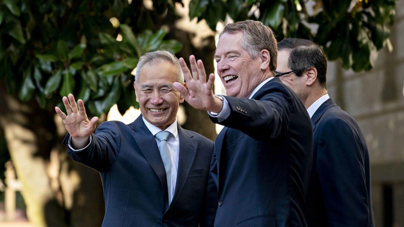 Liu He, China's vice premier (left) and Robert Lighthizer, U.S. trade representative, wave to members of the media before a meeting at the Office of the U.S. Trade Representative in Washington on Oct. 11, 2019. PHOTO CREDIT: Bloomberg photo by Andrew Harrer.