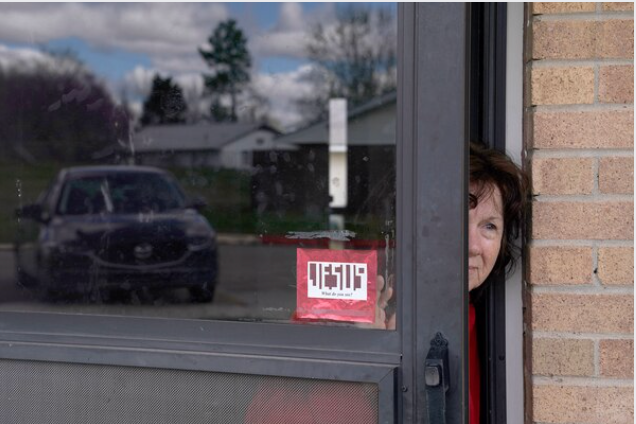 Patricia Flood, who has COPD and other health issues, peeks out of her front door in Bristow, Okla. MUST CREDIT: Photo for The Washington Post by Nick Oxford
