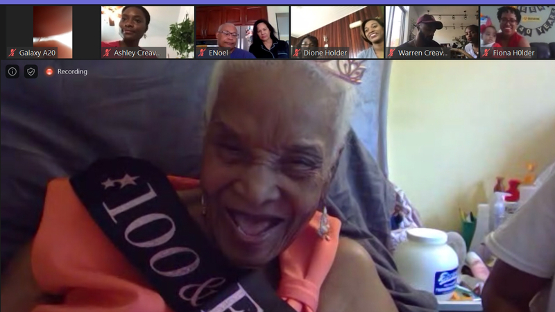 Victorine Creavalle laughs as her relatives congratulate her on her 100th birthday Sunday, May 24, 2020. MUST CREDIT: Washington Post photo by Julie Zauzmer
