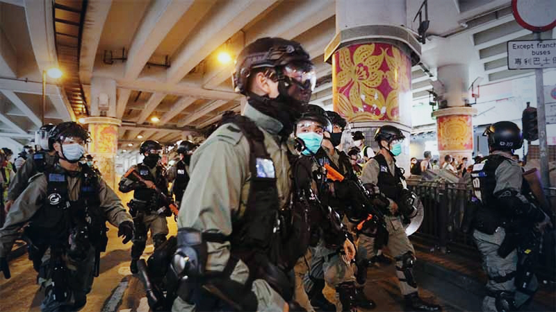 Riot police charge at demonstrators during a protest against a planned national security law in the Wan Chai district of Hong Kong on Sunday, May 24, 2020. MUST CREDIT: Bloomberg photo by May James
