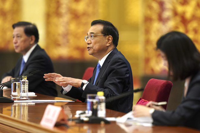 Premier Li Keqiang answers questions at a news conference after the conclusion of the national legislative session on May 28, 2020, in Beijing. [Photo by Feng Yongbin/China Daily]