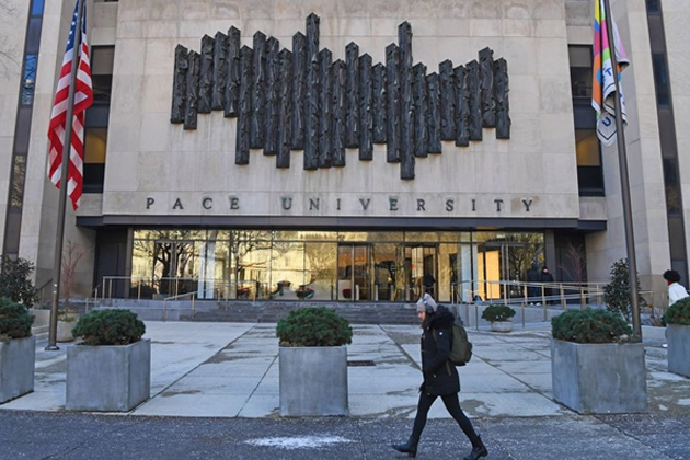 A student walks past a building of Pace University in New York, the United States, Dec. 19, 2019. [Photo/Xinhua]