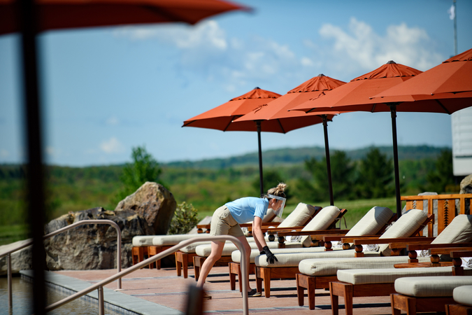 Staff in protective face shields prepare the pool area for guests on May 30,2020, at Falling Rock, one of several hotels at Nemacolin Woodlands Resort in Wharton, Pa. MUST CREDIT: Photo for The Washington Post by Jeff Swensen
