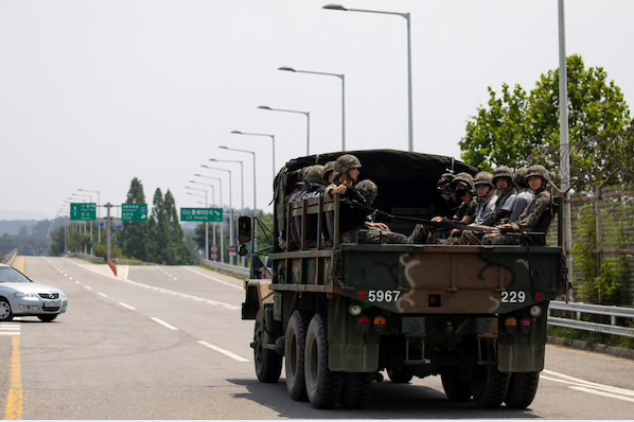 A military vehicle carrying Republic of Korea Army (ROK) soldiers travels along a road near the demilitarized zone (DMZ) in Paju, South Korea, on June 17, 2020. MUST CREDIT: Bloomberg photo by SeongJoon Cho.