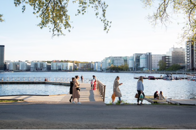 A group of people socialize on a jetty on the water's edge in Stockholm, Sweden, on May 22, 2020. MUST CREDIT: Bloomberg photo by Loulou D'Aki