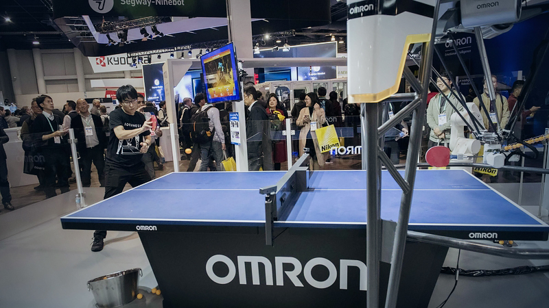 An attendee plays table tennis with Omron Corp.'s Forpheus artificial intelligence robot during CES 2020 in Las Vegas on Jan. 8, 2020. MUST CREDIT: Bloomberg photo by Bridget Bennett.