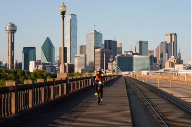 A person rides a bicycle along a nearly empty Houston Street Viaduct in Dallas, Texas, on April 15, 2020. MUST CREDIT: Bloomberg photo by Rebecca Smeyne.