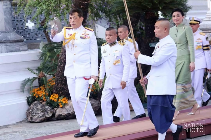 Their Majesties change Emerald Buddha attire to signal wet season Their Majesties change Emerald Buddha attire to signal wet season