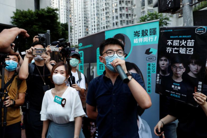Pro-democracy activists Tiffany Yuen Ka-wai (left) and Joshua Wong attend a campaigning during primary elections, in Hong Kong, on July 11, 2020.PHOTO: REUTERS