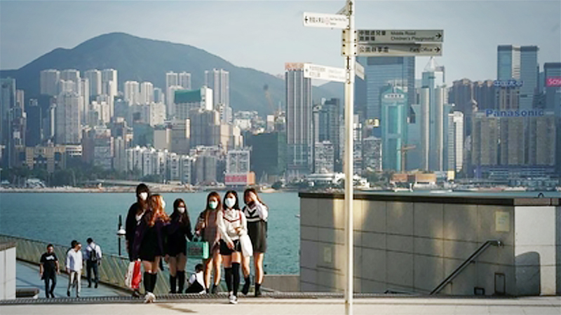 Pedestrians wearing face masks are seen at the Avenue of Stars in Tsim Sha Tsui of Hong Kong, Feb 23, 2020. (LI GANG/XINHUA)