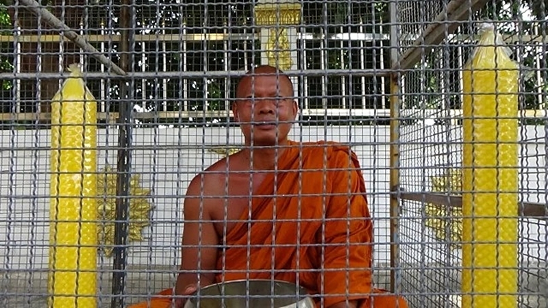 Abbot locks himself in dog cage in protest Abbot locks himself in dog cage in protest