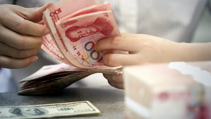 A staff member counts Chinese currency renminbi at a bank in Linyi, East China's Shandong province. [Photo/Xinhua]