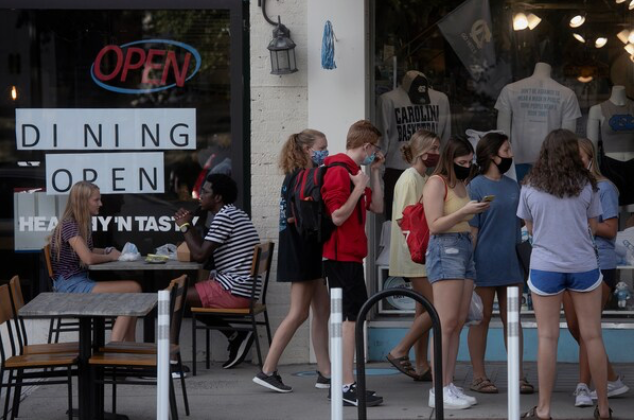 Students at the University of North Carolina at Chapel Hill gather along Franklin Street on Aug. 9, 2020. MUST CREDIT: Photo for The Washington Post by Ted Richardson
