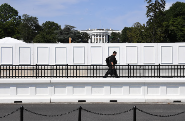 A law enforcement officer is seen Wednesday outside the grounds of the White House, where events related to the Republican National Convention, including the president's keynote speech, are being staged.  CREDIT: Washington Post photo by Matt McClain
