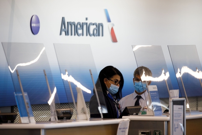 Employees stand behind plastic shielding in the American Airlines check-in counter area at O'Hare International Airport in Chicago, Illinois, on June 13, 2020. MUST CREDIT: Bloomberg photo by Patrick T. Fallon.
Photo by: Patrick T. Fallon — Bloomberg
Location: Chicago, United States
