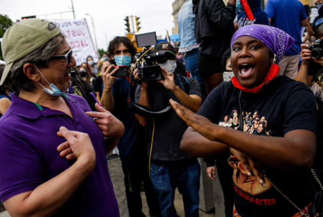 A supporter of President Donald Trump, left, argues with a counterprotester outside the Kenosha County Courthouse on Tuesday in Kenosha, Wis. CREDIT: Photo by Joshua Lott for The Washington Post