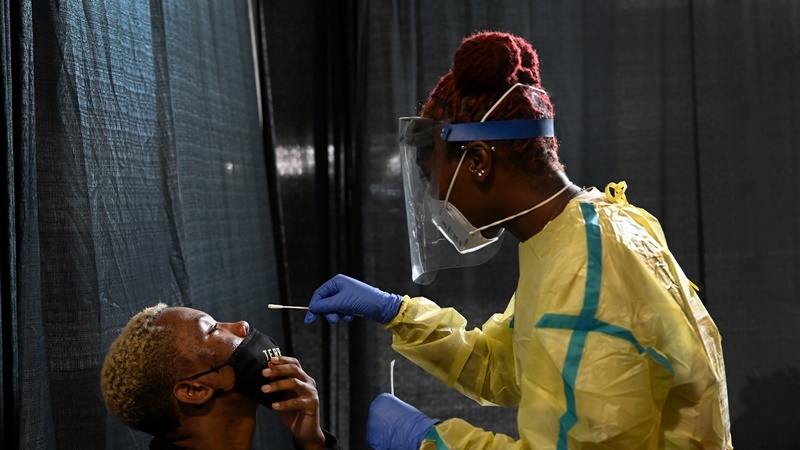 University of Maryland junior Shamar Jackson, 23, came to Capital One Field at Maryland Stadium on Tuesday to get tested for the novel coronavirus on the second day of the school year. Agnelyne Ndifor, a nursing student at Towson University, used a nasal swab to collect a specimen for laboratory analysis. MUST CREDIT: Washington Post photo by Katherine Frey