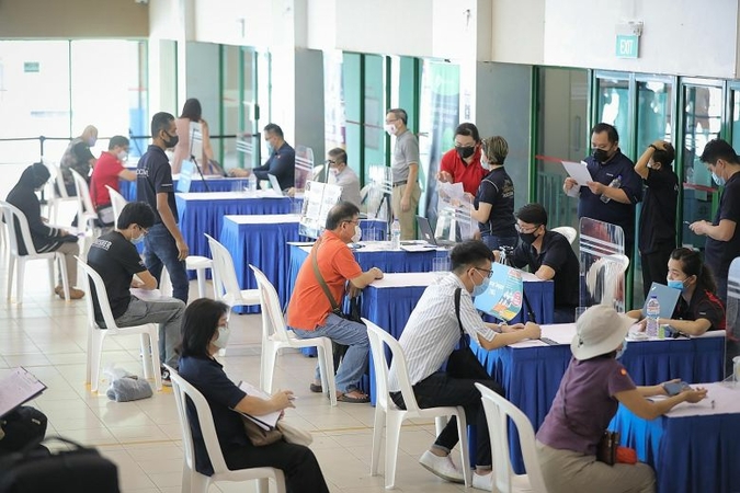 People at a job fair held by the National Trades Union Congress' Employment and Employability Institute at Chong Pang Community Club last month. Retrenchments more than doubled in the second quarter of this year, with 6,700 workers laid off, up from 3,220 in the first quarter, and this is only the tip of a large iceberg, warned observers. ST PHOTO: ONG WEE JIN
