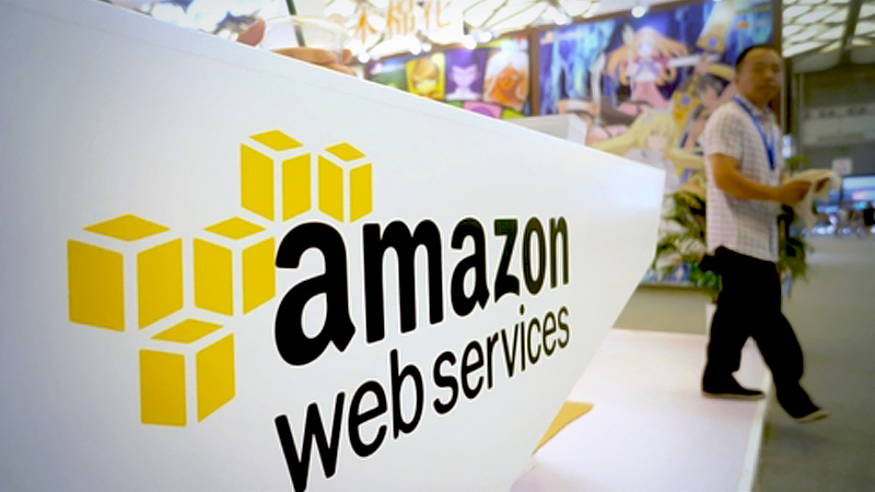A visitor passes an Amazon Web Services booth during a digital expo in Shanghai. [Photo by Long Wei/For China Daily]