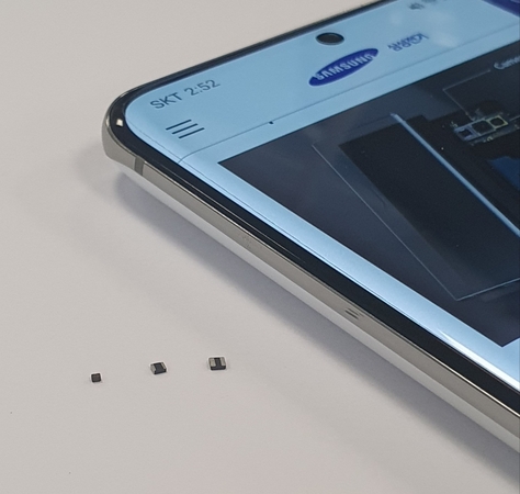 The world’s smallest power inductors, developed by Samsung Electro-Mechanics, are shown on a fingertip. (Samsung Electro-Mechanics)