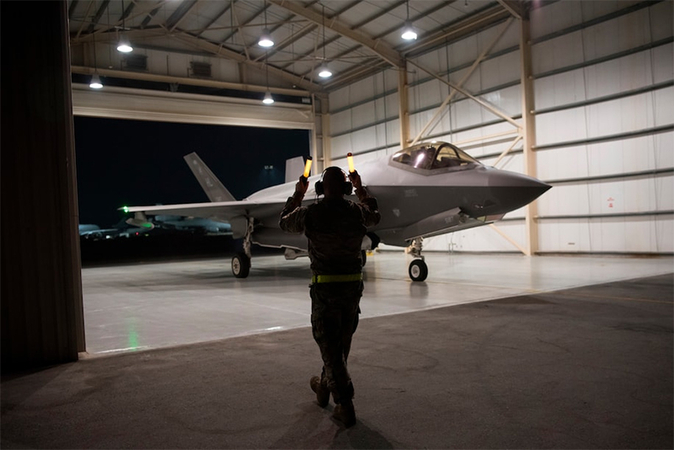 An F-35A Lightning II fighter jet is directed out of a hangar at Al-Dhafra Air Base in the United Arab Emirates in 2019. (Tech. Sgt. Jocelyn Ford/U.S. Air Force/AP)