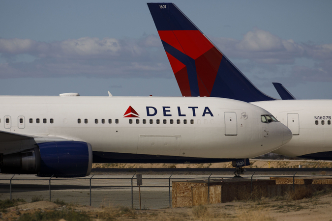 Delta Air Lines Inc. aircraft sit parked at a field in Victorville, Calif., on March 23, 2020. MUST CREDIT: Bloomberg photo by Patrick T. Fallon.