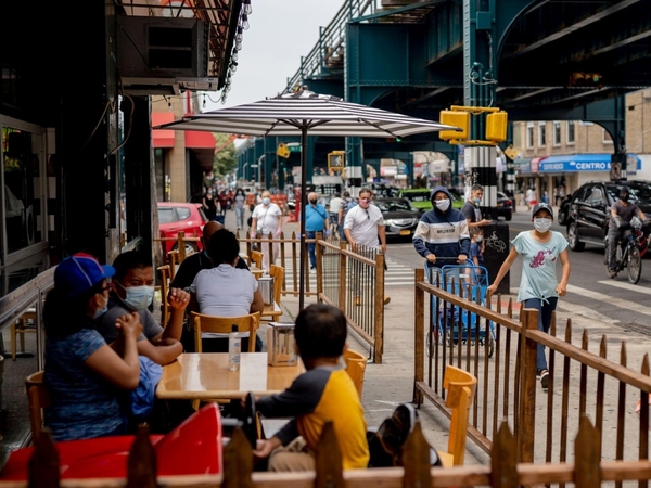 Pedestrians pass in front of customers sitting outside at a restaurant in in the Queens borough of New York on June 27, 2020. MUST CREDIT: Bloomberg photo by Amir Hamja.
Photo by: Amir Hamja — Bloomberg
Location: New York, United States