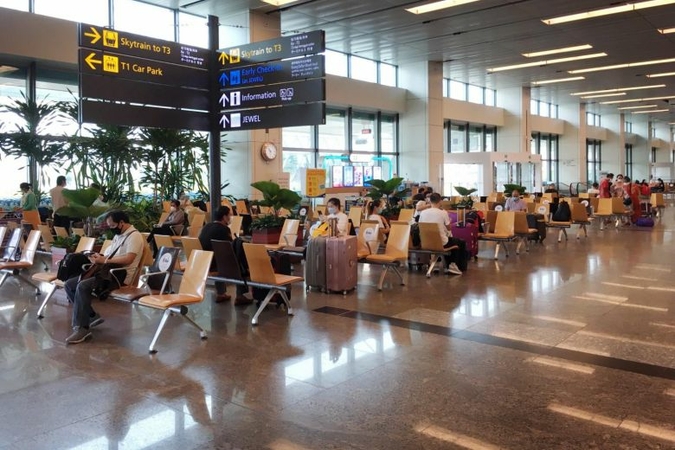Passengers wait to board a flight at the Changi Airport Terminal 1 departure hall on Aug 3, 2020. PHOTO: ST FILE