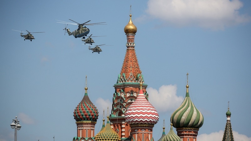 A Mil MI-26 heavy transport helicopter, center, flies over the Kremlin during the victory day parade in Moscow on June 24, 2020. MUST CREDIT: Bloomberg photo by Andrey Rudakov.