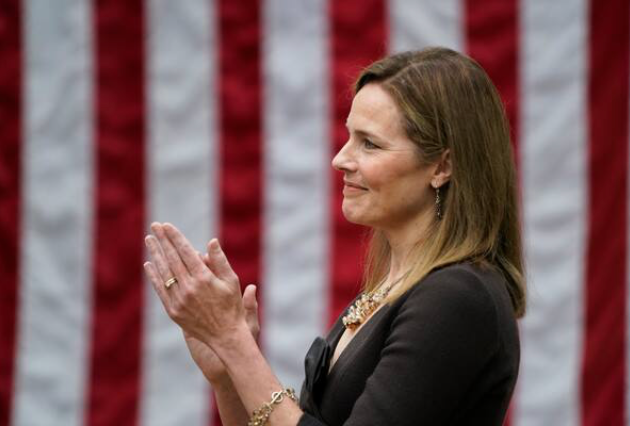 Judge Amy Coney Barrett applauds as President Trump announces her nomination to the Supreme Court on Saturday night at the White House. MUST CREDIT: Washington Post photo by Jabin Botsford

