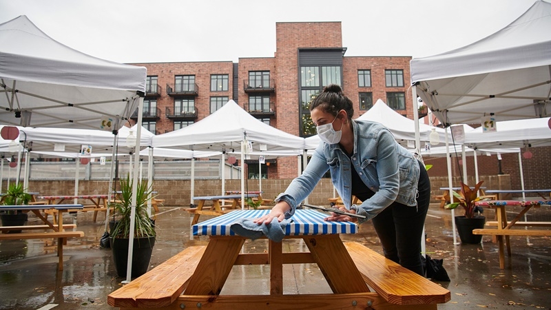 Talia Light gets Kachka restaurant ready for table service outdoors on a recent rainy day in Portland, Ore. MUST CREDIT: photo for The Washington Post by Leah Nash.