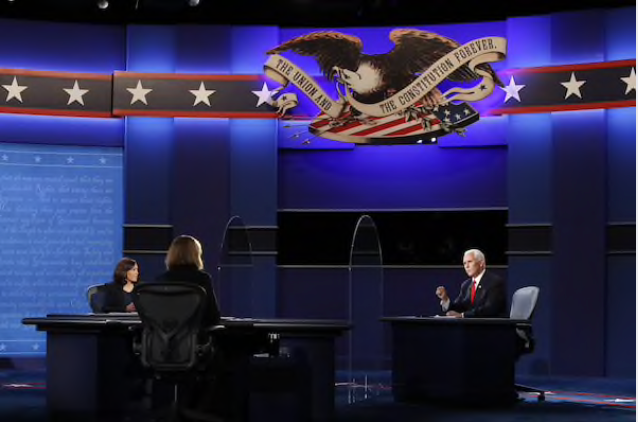 Vice President Mike Pence, right, speaks as Sen. Kamala Harris, Democratic vice presidential nominee, left, listens during the vice presidential debate at the University of Utah in Salt Lake City on Oct. 7, 2020. MUST CREDIT: Bloomberg photo by Kim Raff.