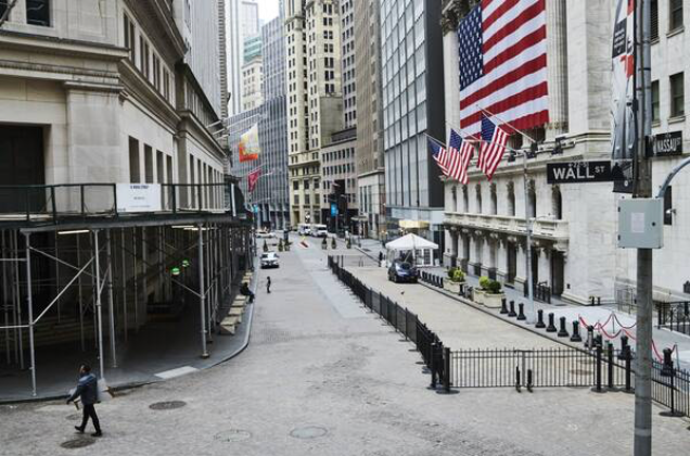 Pedestrians walk past the New York Stock Exchange on a nearly empty Wall Street in New York on March 30, 2020. MUST CREDIT: Bloomberg photo by Gabby Jones.
