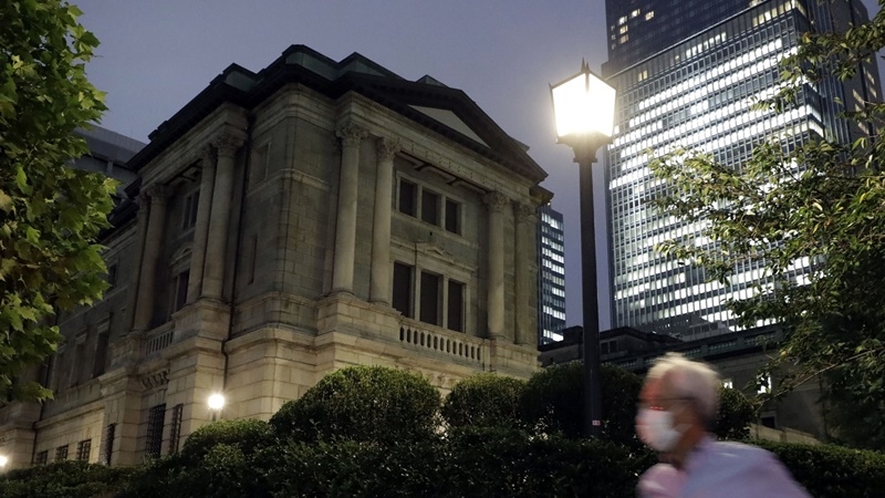 A pedestrian wearing a protective face mask walks past the Bank of Japan headquarters at dusk in Tokyo on Sept. 14, 2020. MUST CREDIT: Bloomberg photo by Kiyoshi Ota.