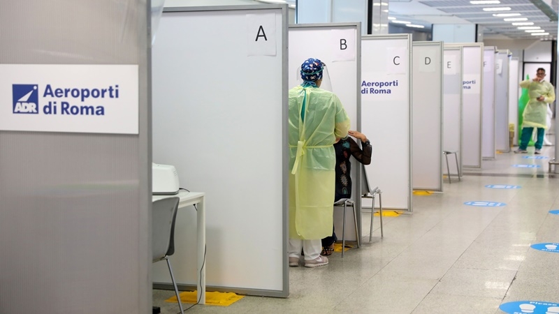 A health-care worker wearing personal protective equipment collects a swab sample from a passenger at the covid-19 rapid test facility at Fiumicino Airport in Rome on Sept. 25, 2020. MUST CREDIT: Bloomberg photo by Alessia Pierdomenico