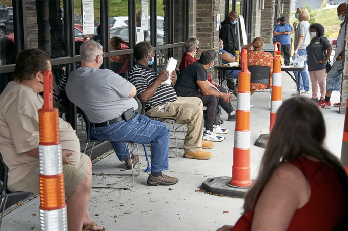 Job seekers wait to be called into a workforce office in Omaha in July- (Nati Harnik/ AP)