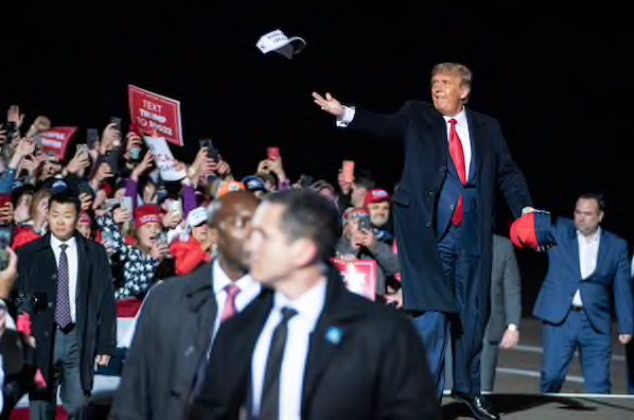 President Donald Trump throws hats to the crowd as he arrives for a campaign event at the Duluth International Airport on Sept. 30, in Duluth, Minn. MUST CREDIT: Washington Post photo by Jabin Botsford