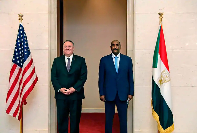 Secretary of State Mike Pompeo, left, stands with Sudanese Gen. Abdel-Fattah al-Burhan, head of the transitional military government, in Khartoum on Aug.
25. (Sudanese Cabinet/ AP)