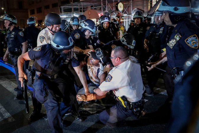 A protester is arrested on Manhattan's Fifth Avenue in June. (John Minchillo/ AP)