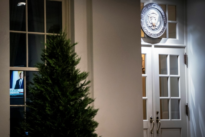 A television is seen through a window near the entrance to the West Wing of the White House on Tuesday night. President Trump's sole public event this week was a wreath-laying at a Veterans Day ceremony. Washington Post photo by Jabin Botsford