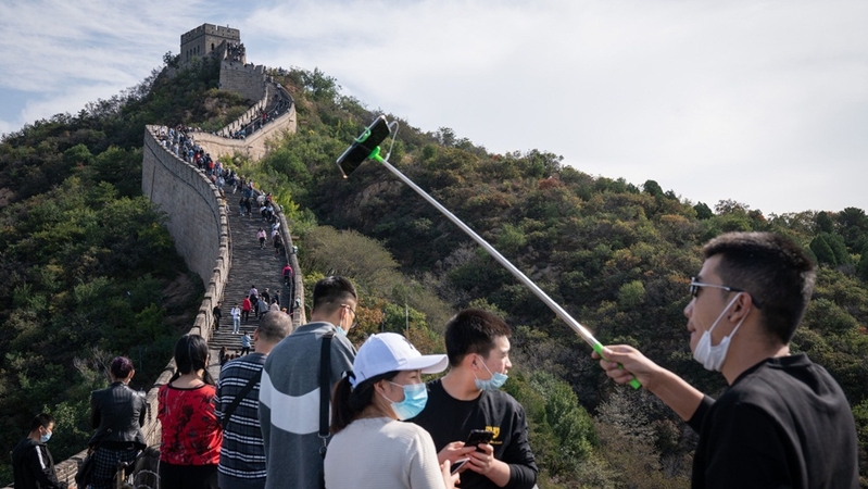 A visitor poses for a selfie photograph at the Badaling section of the Great Wall in Beijing on Oct. 1, 2020. MUST CREDIT: Bloomberg photo by Yan Cong