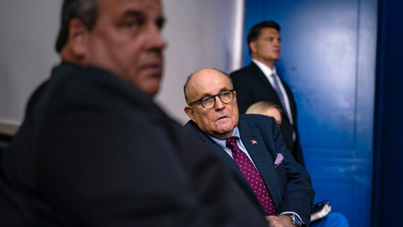 Former New York City mayor Rudy Giuliani, center, and former New Jersey governor Chris Christie, left, listen as President Donald Trump speaks during a news briefing Sept. 27 at the White House. MUST CREDIT: Washington Post photo by Salwan Georges