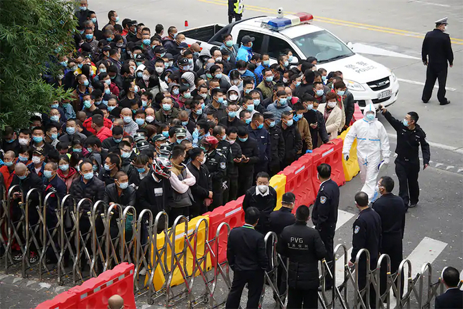 Airport workers wait for coronavirus tests at the Shanghai Pudong International Airport on Monday. (AP)