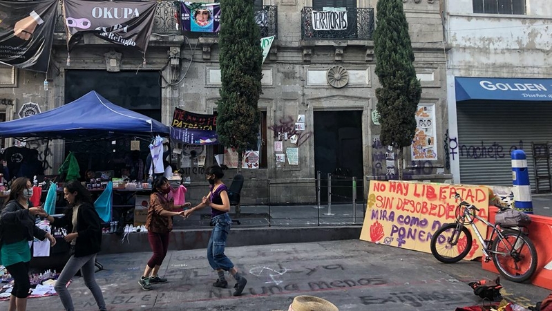 Feminist activists and artists dance outside the Mexican human rights office, which for two months has been run as a shelter for women and children. MUST CREDIT: Washington Post photo by Marissa Lang