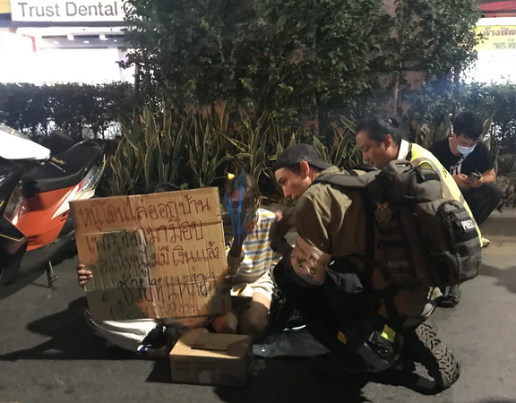 Two girls, who claim to have been thrown out of their homes for joining the anti-government demonstrations, ask for donations at the Lat Phrao protest site in Bangkok on Friday.
