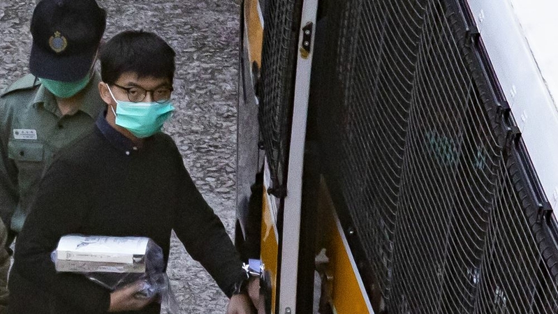 Joshua Wong, activist and former members of pro-democracy party Demosisto, walks towards a Correctional Services Department vehicle ahead of being transported to West Kowloon Magistrates' Courts in Hong Kong on Dec. 2, 2020. MUST CREDIT: Bloomberg photo by Paul Yeung.