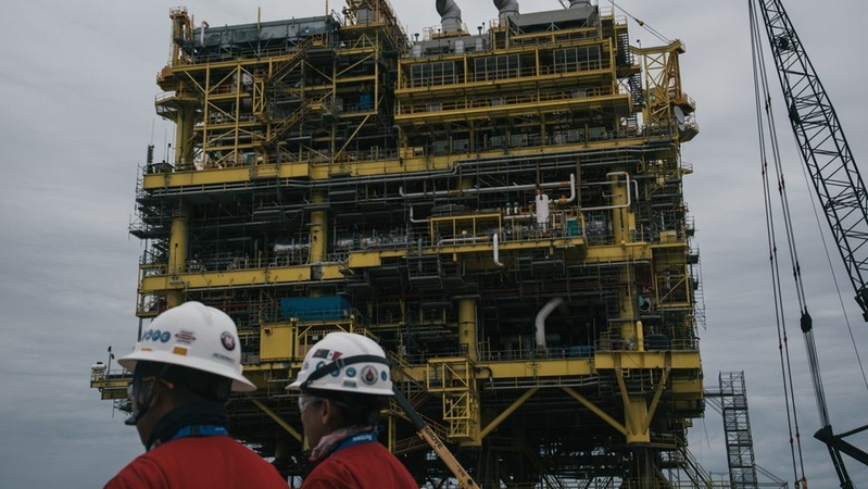 Employee pass in front of the finished Abkatun-A2 oil platform at the Mcdermott International Inc. fabrication facility in Altamira, Mexico, on Nov. 2, 2018. MUST CREDIT: Bloomberg photo by Luis Antonio Rojas.
