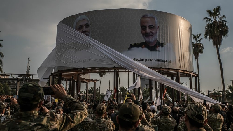 Members of the Hashd al-Shaabi militia watch as photos featuring Qasem Soleimani and Abu Mahdi al-Muhandis are unveiled in Karrada, Baghdad, on Jan. 20. MUST CREDIT: photo for The Washington Post by Emilienne Malfatto.