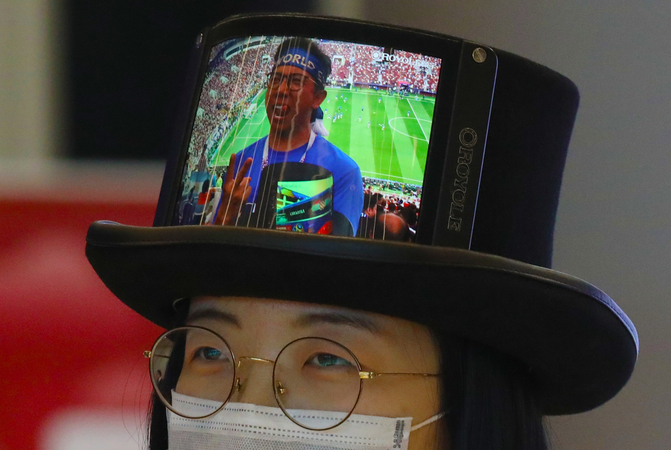 A volunteer wears a hat mounted with a flexible display during the ZGC Forum in Beijing on Sept 17. [Photo by Zhu Xingxin/chinadaily.com.cn]